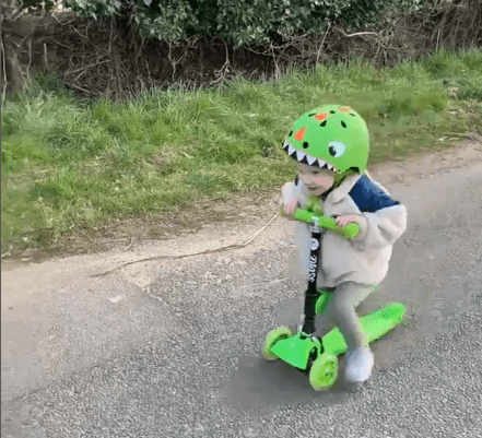 child riding a kids scooter that was an xmas gift