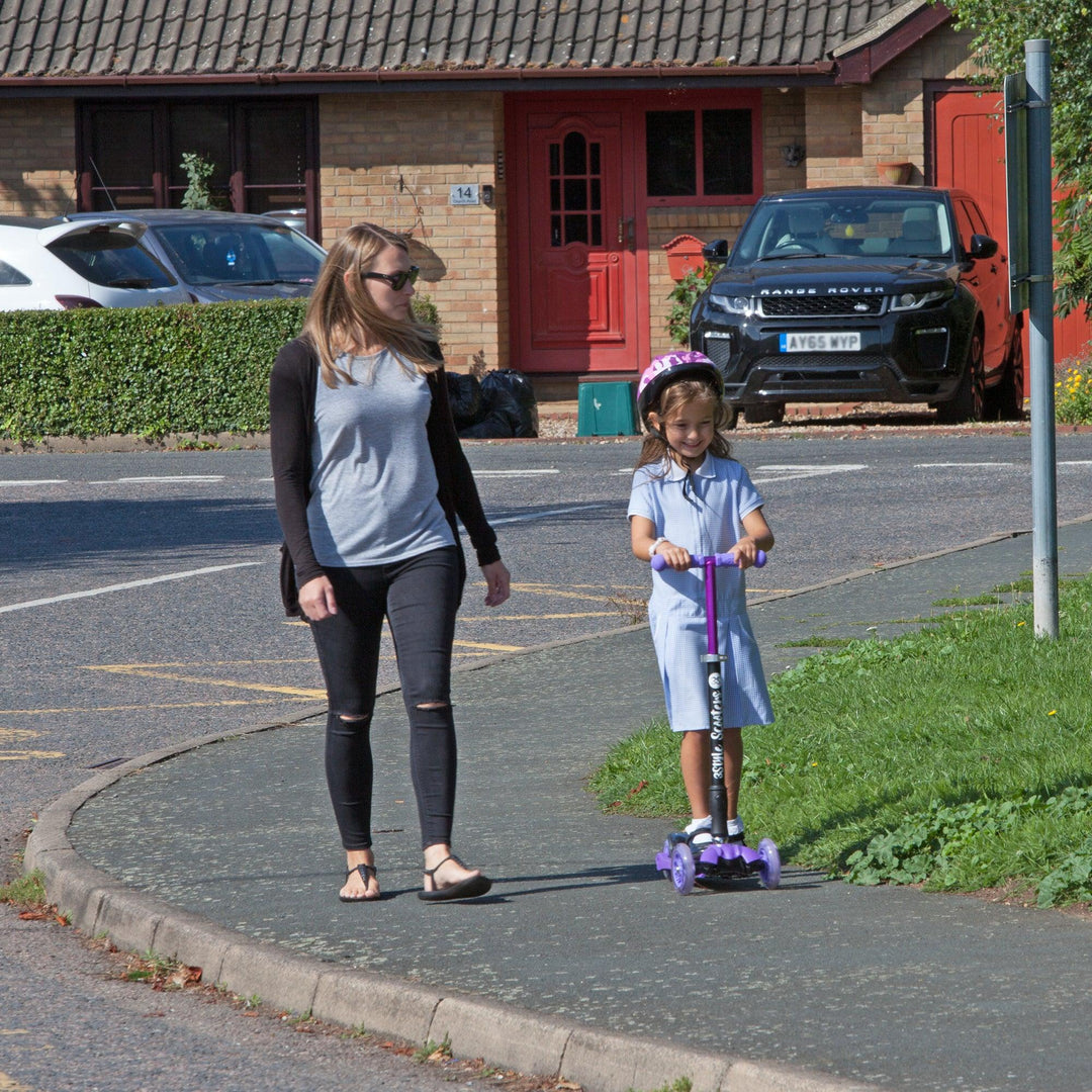 Kid scooting to school with mum